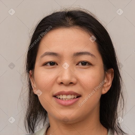 Joyful latino young-adult female with medium  brown hair and brown eyes