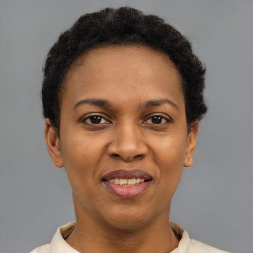 Joyful black adult female with short  brown hair and brown eyes