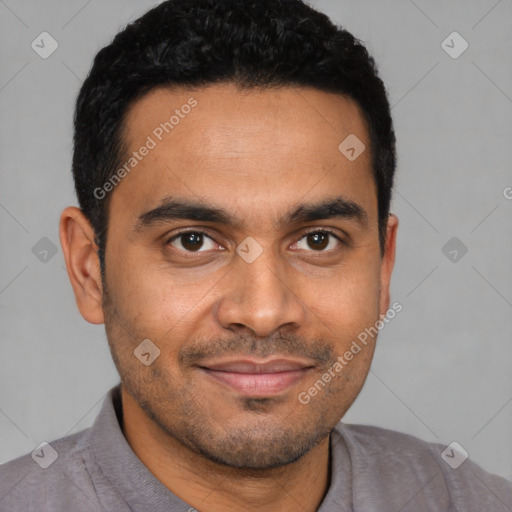 Joyful latino young-adult male with short  brown hair and brown eyes