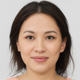 Joyful asian young-adult female with medium  brown hair and brown eyes