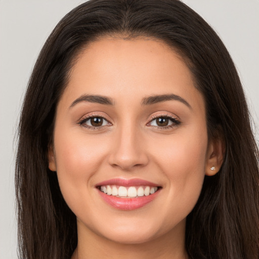 Joyful white young-adult female with long  brown hair and brown eyes