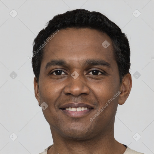Joyful black young-adult male with short  black hair and brown eyes