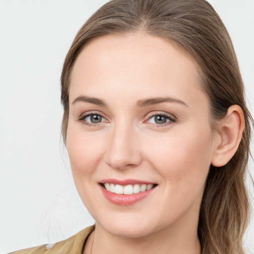 Joyful white young-adult female with long  brown hair and blue eyes