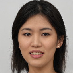 Joyful asian young-adult female with long  brown hair and brown eyes