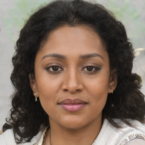 Joyful black young-adult female with medium  brown hair and brown eyes