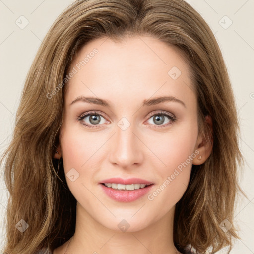 Joyful white young-adult female with long  brown hair and green eyes