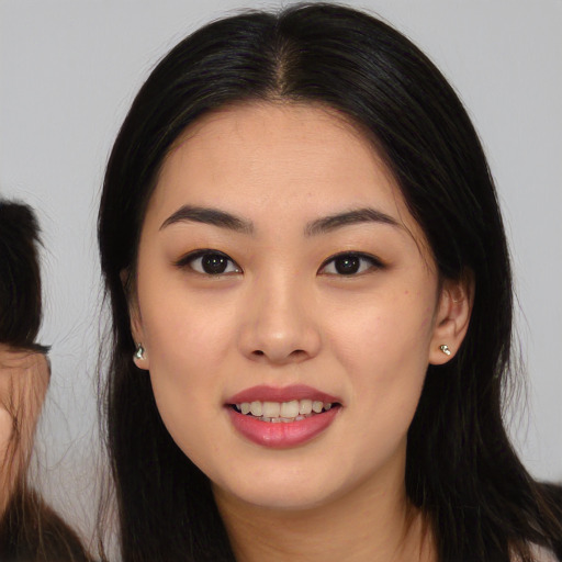 Joyful white young-adult female with long  black hair and brown eyes