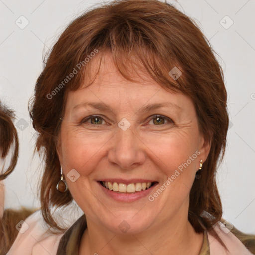 Joyful white adult female with medium  brown hair and blue eyes