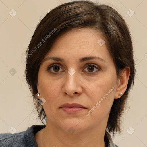 Joyful white adult female with medium  brown hair and grey eyes