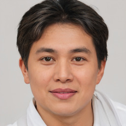 Joyful asian young-adult male with short  brown hair and brown eyes