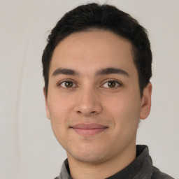 Joyful white young-adult male with short  black hair and brown eyes