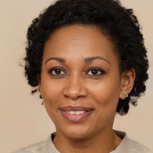 Joyful black adult female with short  brown hair and brown eyes