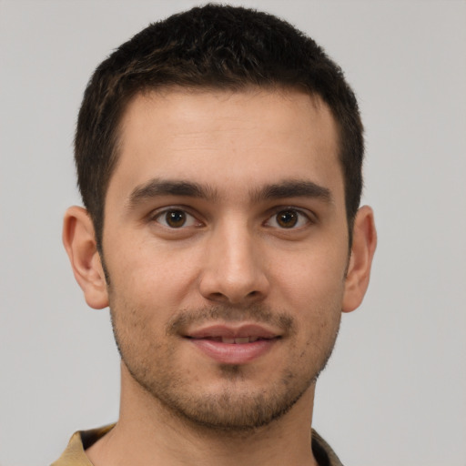 Joyful white young-adult male with short  brown hair and brown eyes