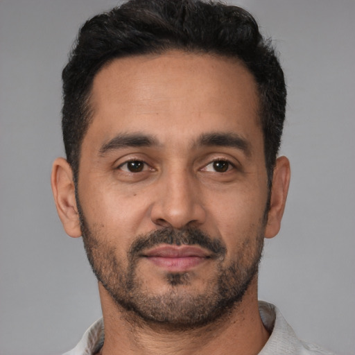 Neutral latino young-adult male with short  black hair and brown eyes