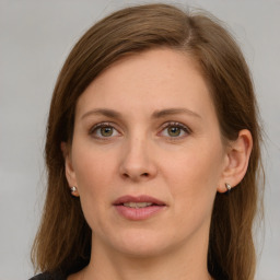 Joyful white young-adult female with long  brown hair and green eyes