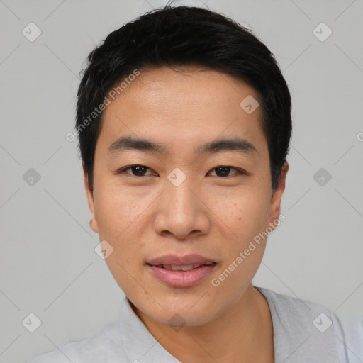 Joyful asian young-adult male with short  black hair and brown eyes