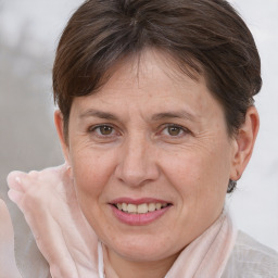 Joyful white adult female with short  brown hair and brown eyes