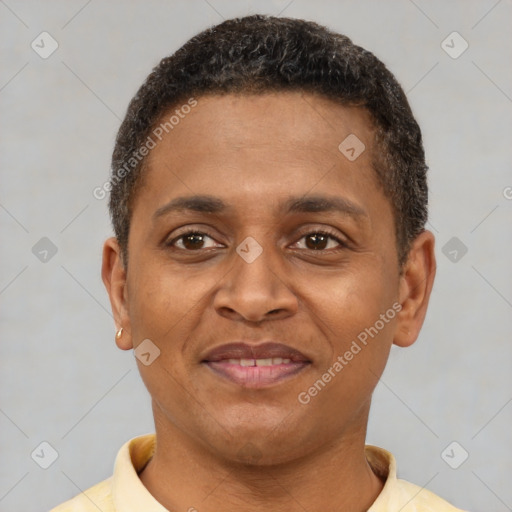Joyful latino young-adult male with short  brown hair and brown eyes