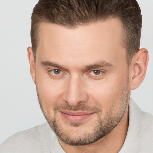 Joyful white adult male with short  brown hair and brown eyes