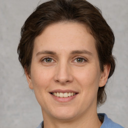 Joyful white adult female with medium  brown hair and grey eyes