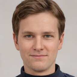 Joyful white young-adult male with short  brown hair and grey eyes