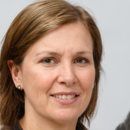 Joyful white adult female with medium  brown hair and grey eyes