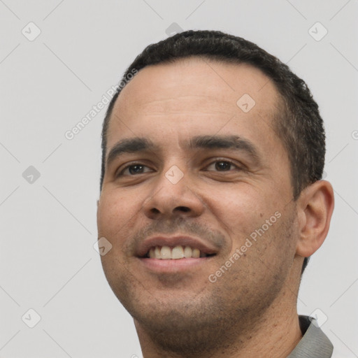 Joyful white young-adult male with short  black hair and brown eyes