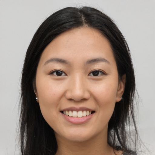 Joyful asian young-adult female with long  brown hair and brown eyes