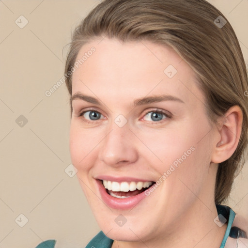 Joyful white young-adult female with medium  brown hair and blue eyes