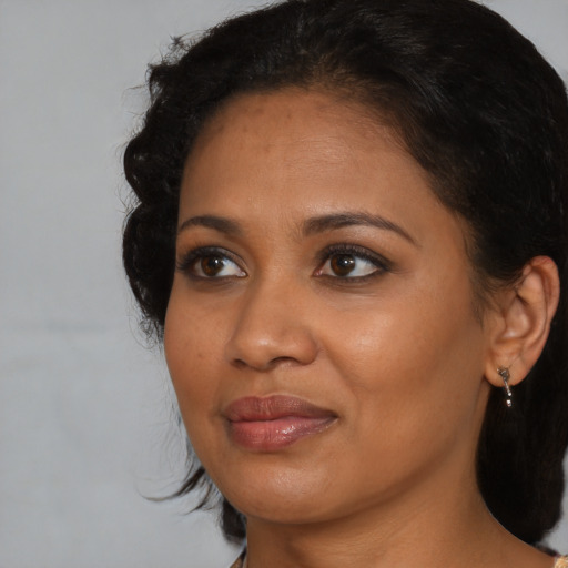 Joyful black young-adult female with medium  brown hair and brown eyes
