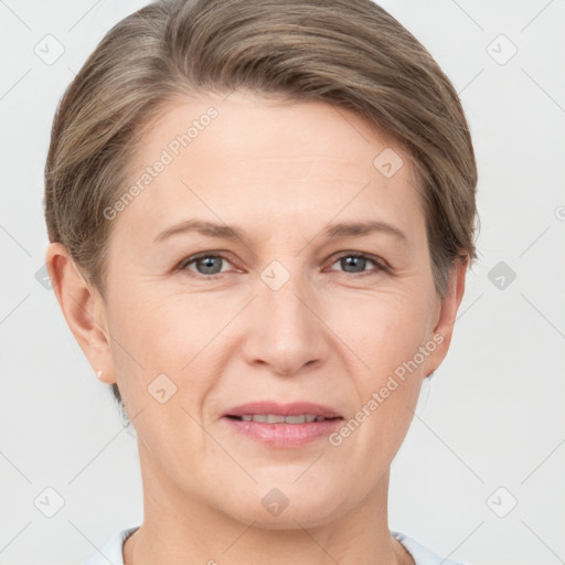 Joyful white adult female with short  brown hair and grey eyes