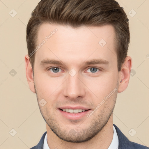 Joyful white young-adult male with short  brown hair and grey eyes