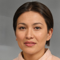 Joyful asian adult female with medium  brown hair and brown eyes