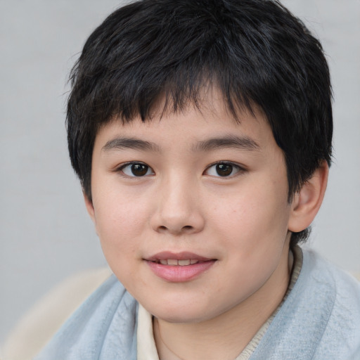 Joyful asian child male with short  brown hair and brown eyes