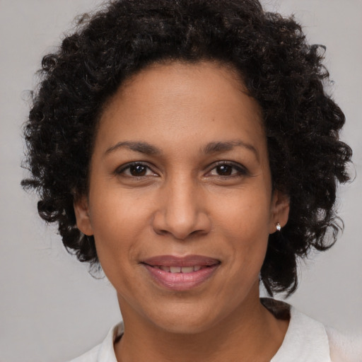 Joyful black adult female with short  brown hair and brown eyes