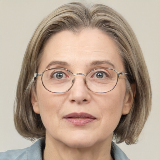 Joyful white middle-aged female with medium  brown hair and grey eyes