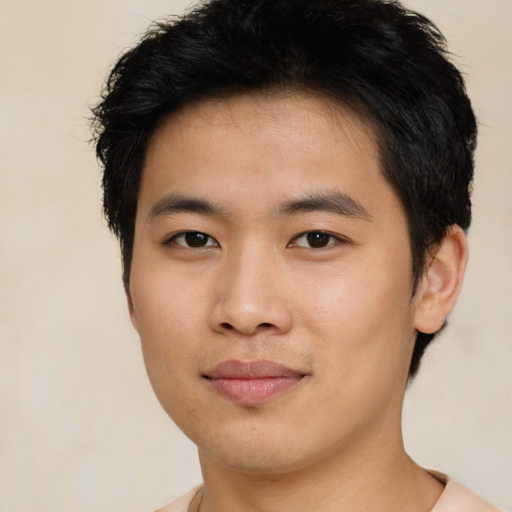 Joyful asian young-adult male with short  black hair and brown eyes