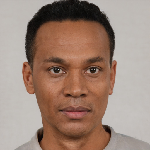 Neutral black adult male with short  black hair and brown eyes