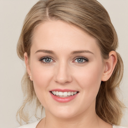 Joyful white young-adult female with medium  brown hair and blue eyes