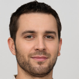 Joyful white young-adult male with short  brown hair and brown eyes