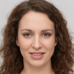 Joyful white young-adult female with long  brown hair and green eyes