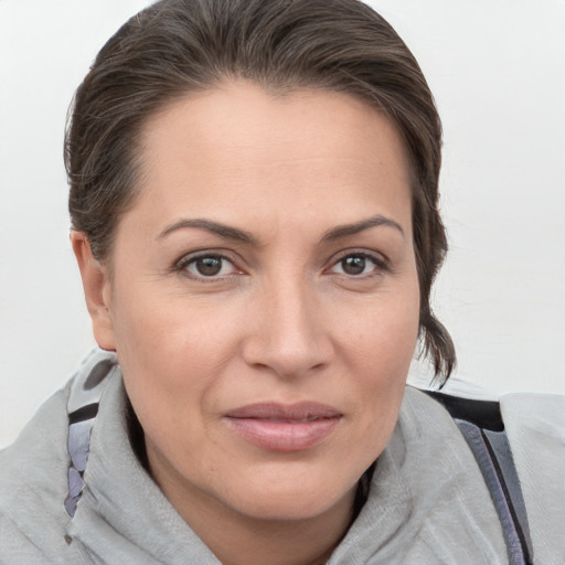 Joyful white adult female with medium  brown hair and brown eyes