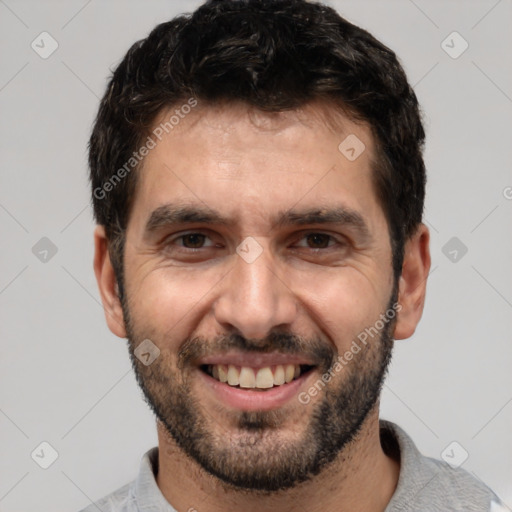 Joyful white adult male with short  black hair and brown eyes