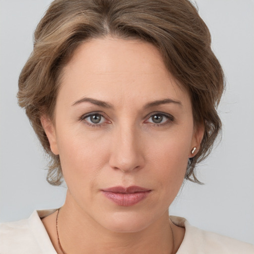 Joyful white adult female with medium  brown hair and brown eyes