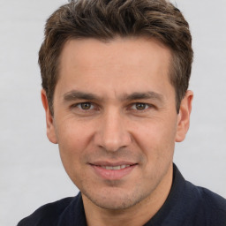 Joyful white adult male with short  brown hair and brown eyes