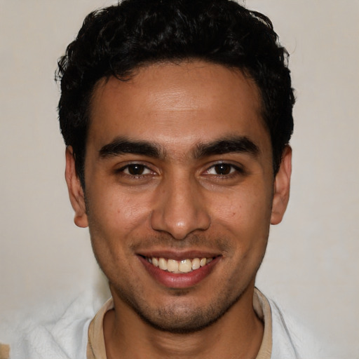 Joyful white young-adult male with short  black hair and brown eyes