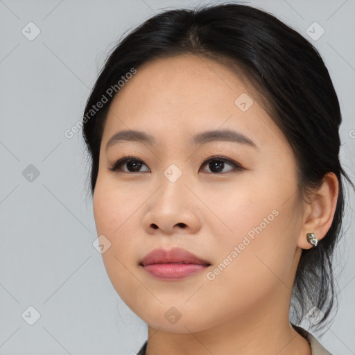 Joyful asian young-adult female with medium  black hair and brown eyes