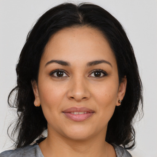 Joyful latino young-adult female with long  black hair and brown eyes