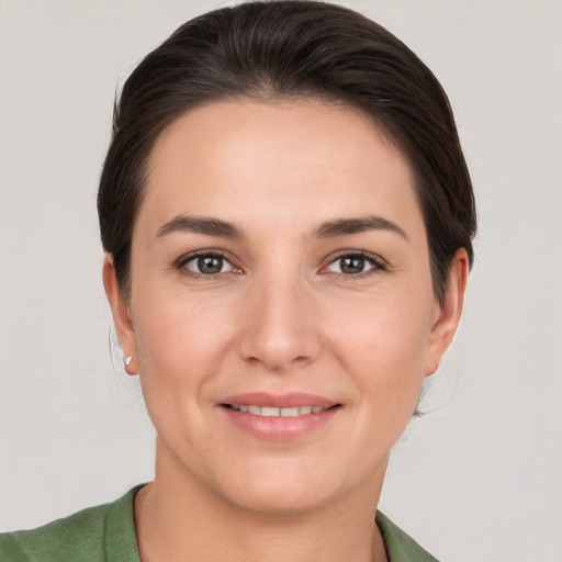 Joyful white young-adult female with short  brown hair and brown eyes