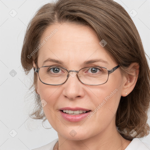 Joyful white adult female with medium  brown hair and blue eyes